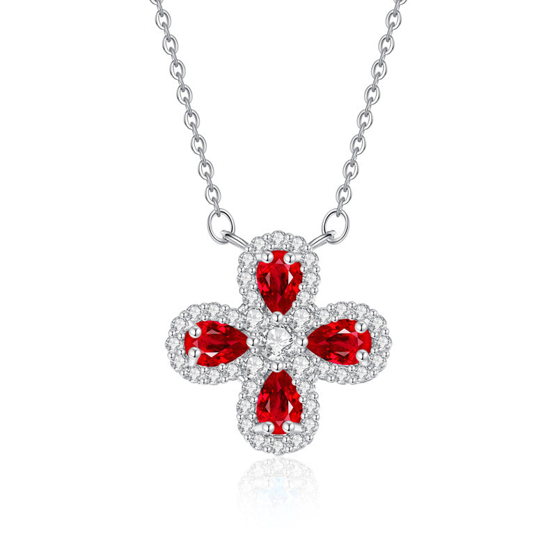 Garnet cross birthstone pendant necklace featuring pear-shaped red garnet stones and pav¨¦ diamond details on a silver chain