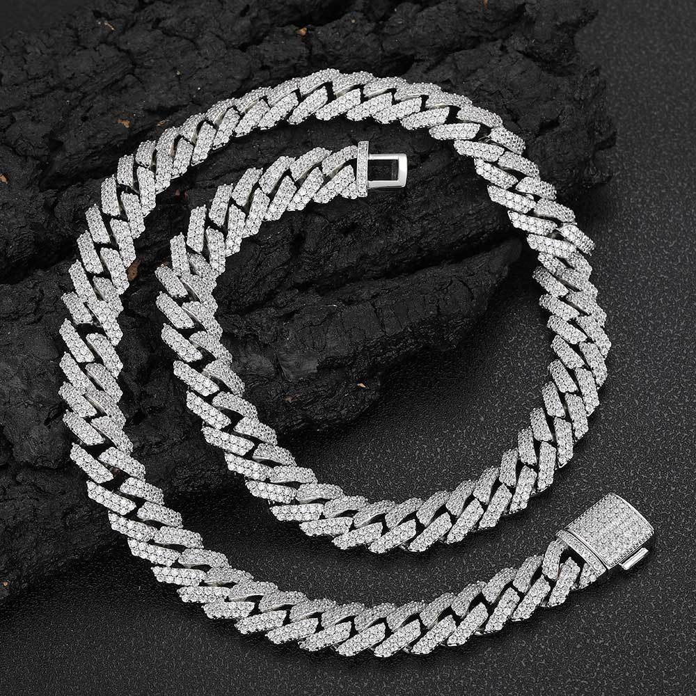 Aeterna Jewelry silver iced-out Cuban link chain on black textured surface