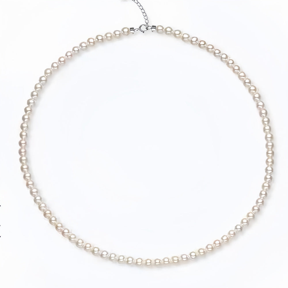 Freshwater pearl necklace with adjustable silver chain, full circle layout showing lustrous white pearls, Aeterna Jewelry minimalist design